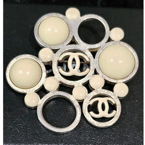 Vintage Chanel Metal Brooch with White Enamel CC Logos and Circular Detail - Picture 1 of 7